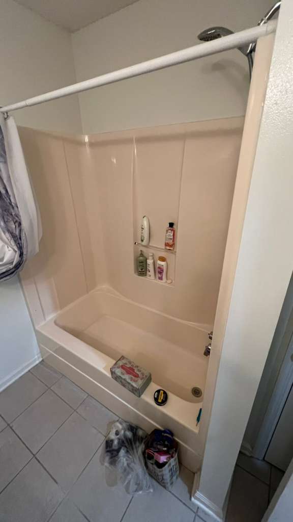 Original bathroom before remodel — old peach fiberglass tub surround before master bath transformation — West Ashley SC