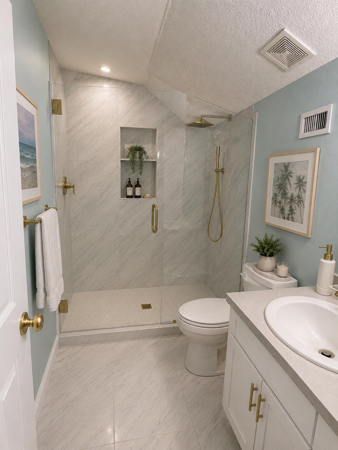 After: fully staged marble-look bathroom with frameless glass shower, gold fixtures and white vanity — Charleston SC
